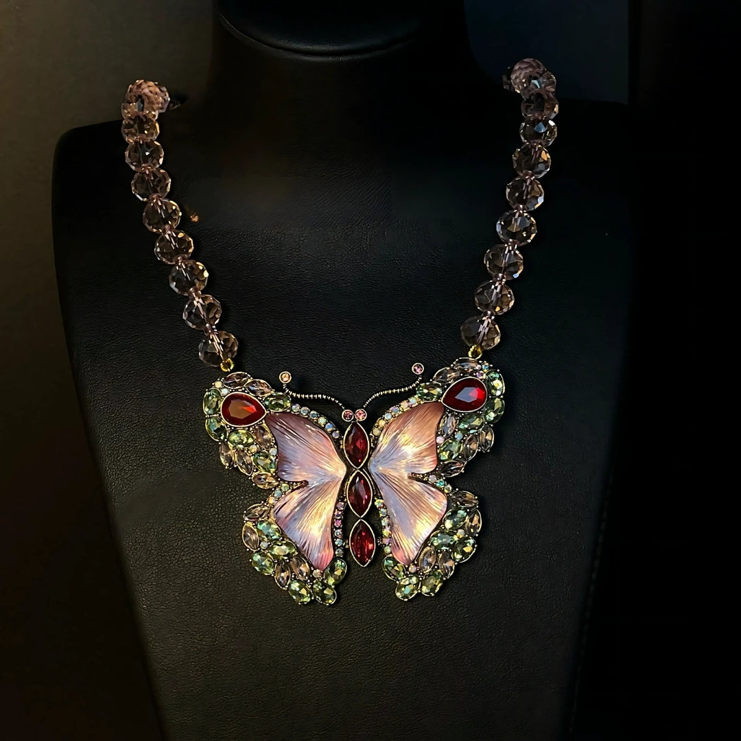 Butterfly-shaped necklace with gemstones on a black background
