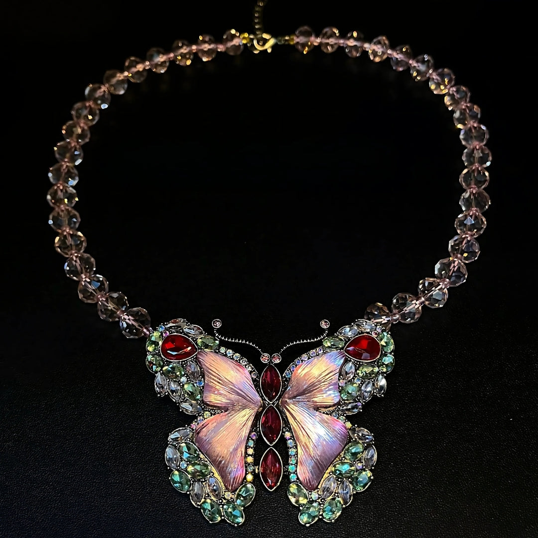 Necklace with a butterfly pendant featuring gemstones on a black background
