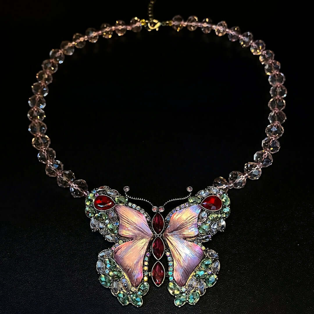 Necklace with a butterfly pendant featuring gemstones on a black background