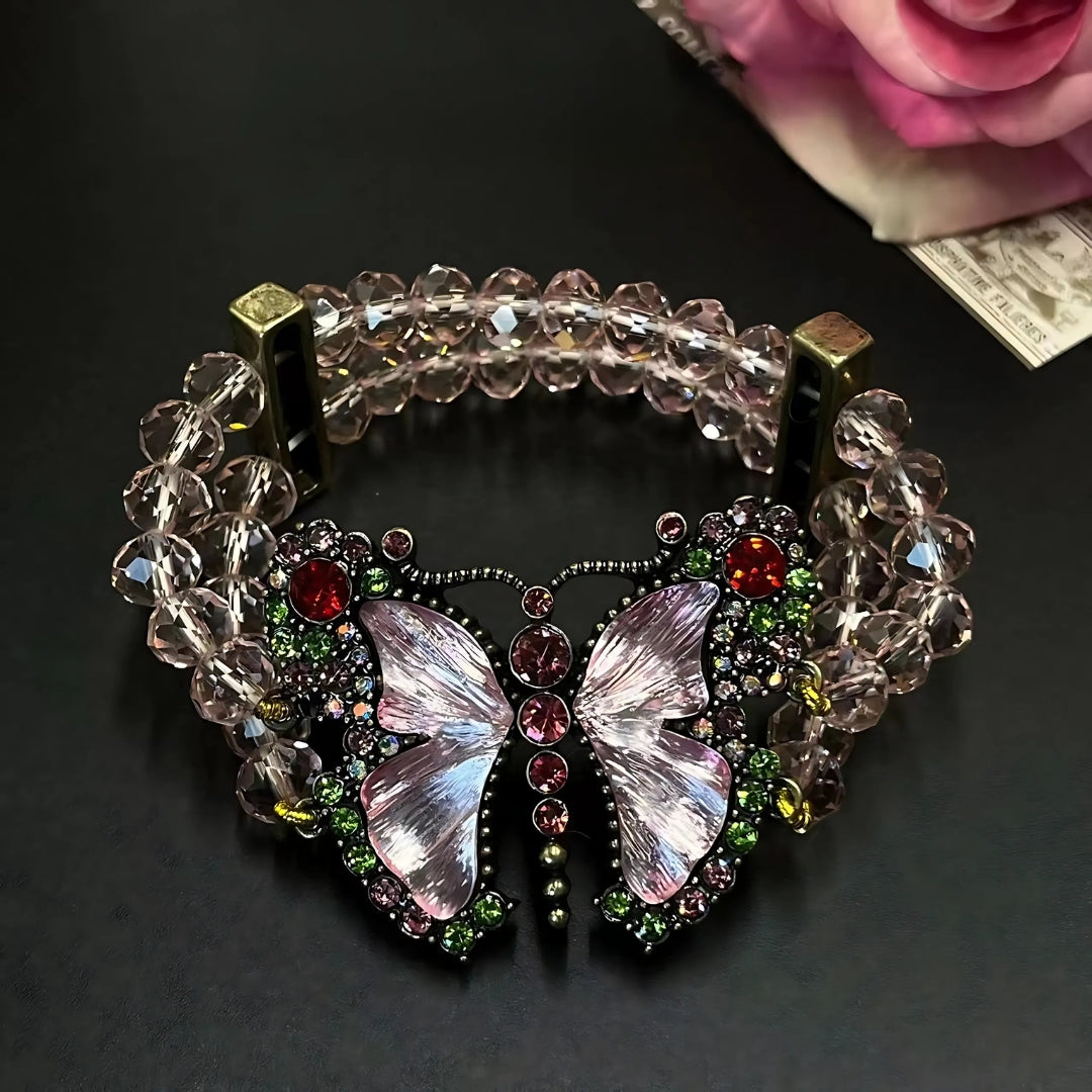 Decorative bracelet with butterfly design and gemstones on a dark background