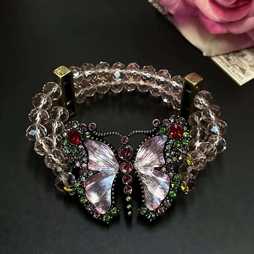 Decorative bracelet with butterfly design and gemstones on a dark background