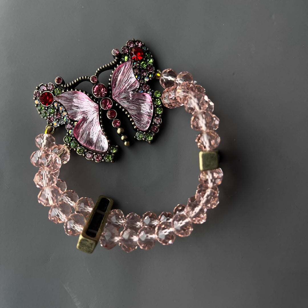 Bracelet with butterfly charm on a gray background