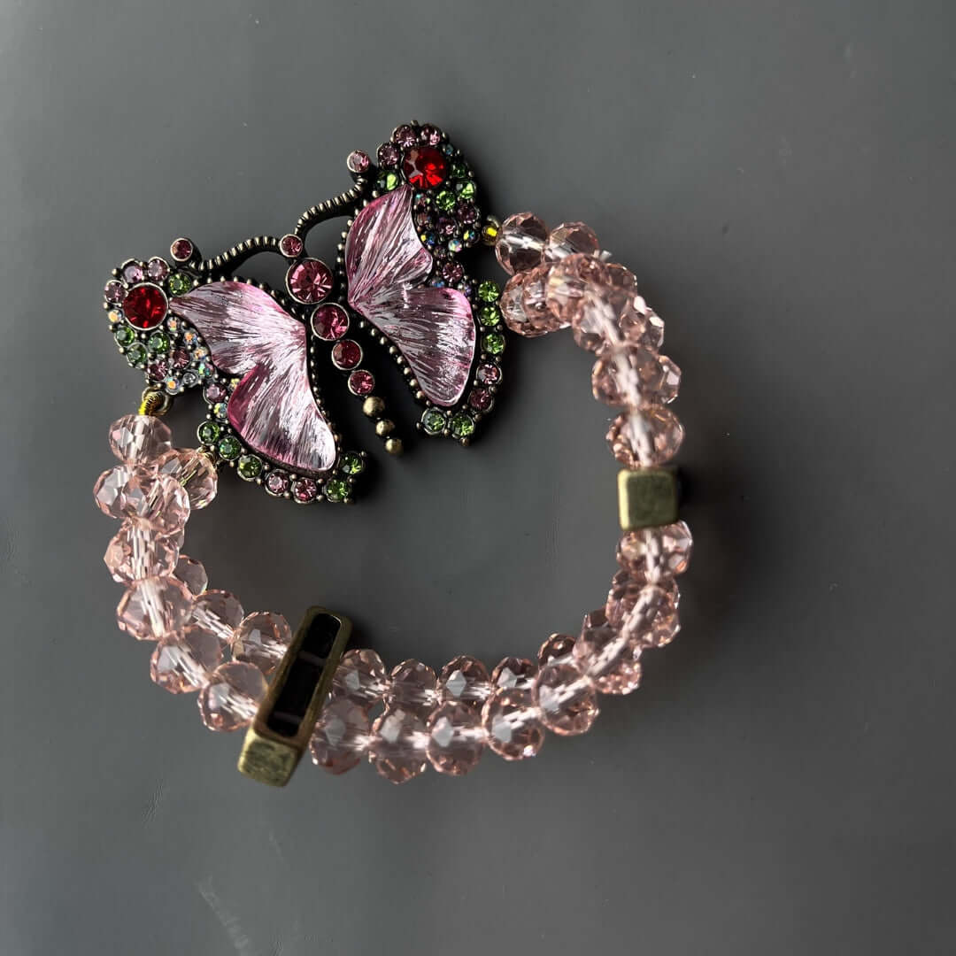 Bracelet with butterfly charm on a gray background