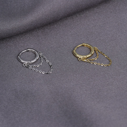 A pair of silver and gold cartilage tassel earrings with chain