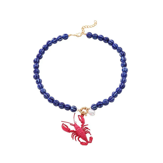 blue beads necklace with pink lobster charm