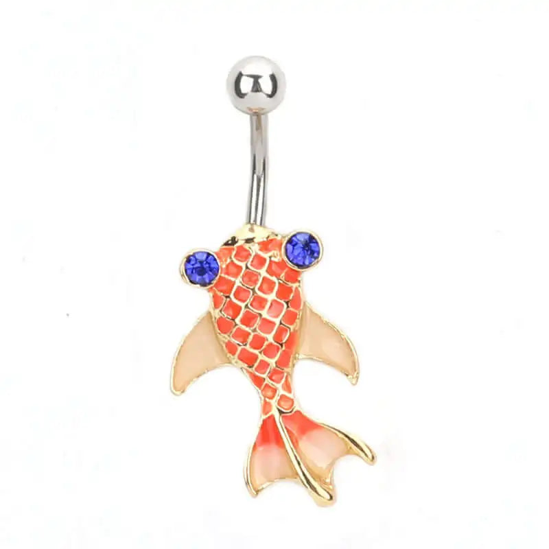 Gold koi fish-shaped belly button ring with blue gemstones on a white background