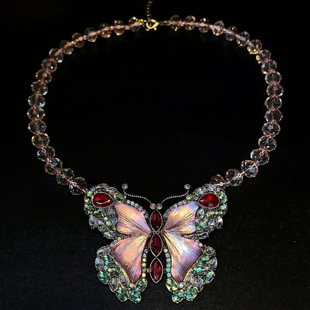Necklace with a butterfly pendant featuring gemstones on a black background