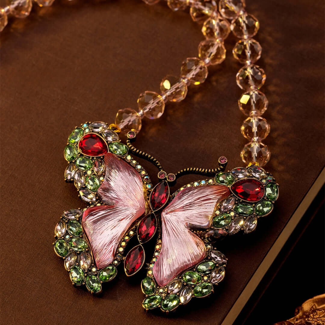 Butterfly-shaped jewelry with gemstones on a brown background