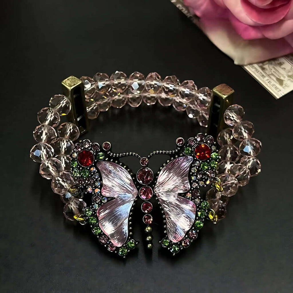 Decorative bracelet with butterfly design and gemstones on a dark background