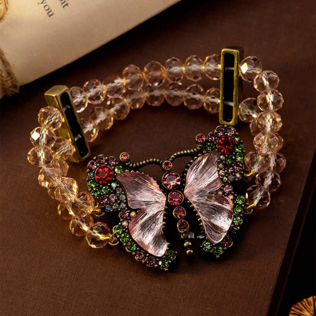 Bracelet with butterfly charm and clear beads on a brown surface