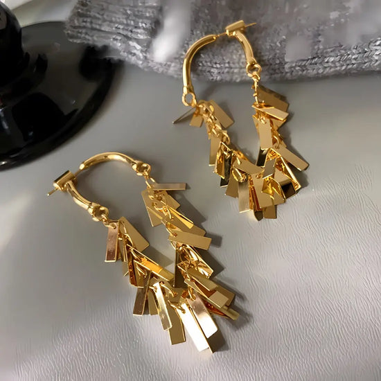 Gold earrings with sequin tassel dangling 