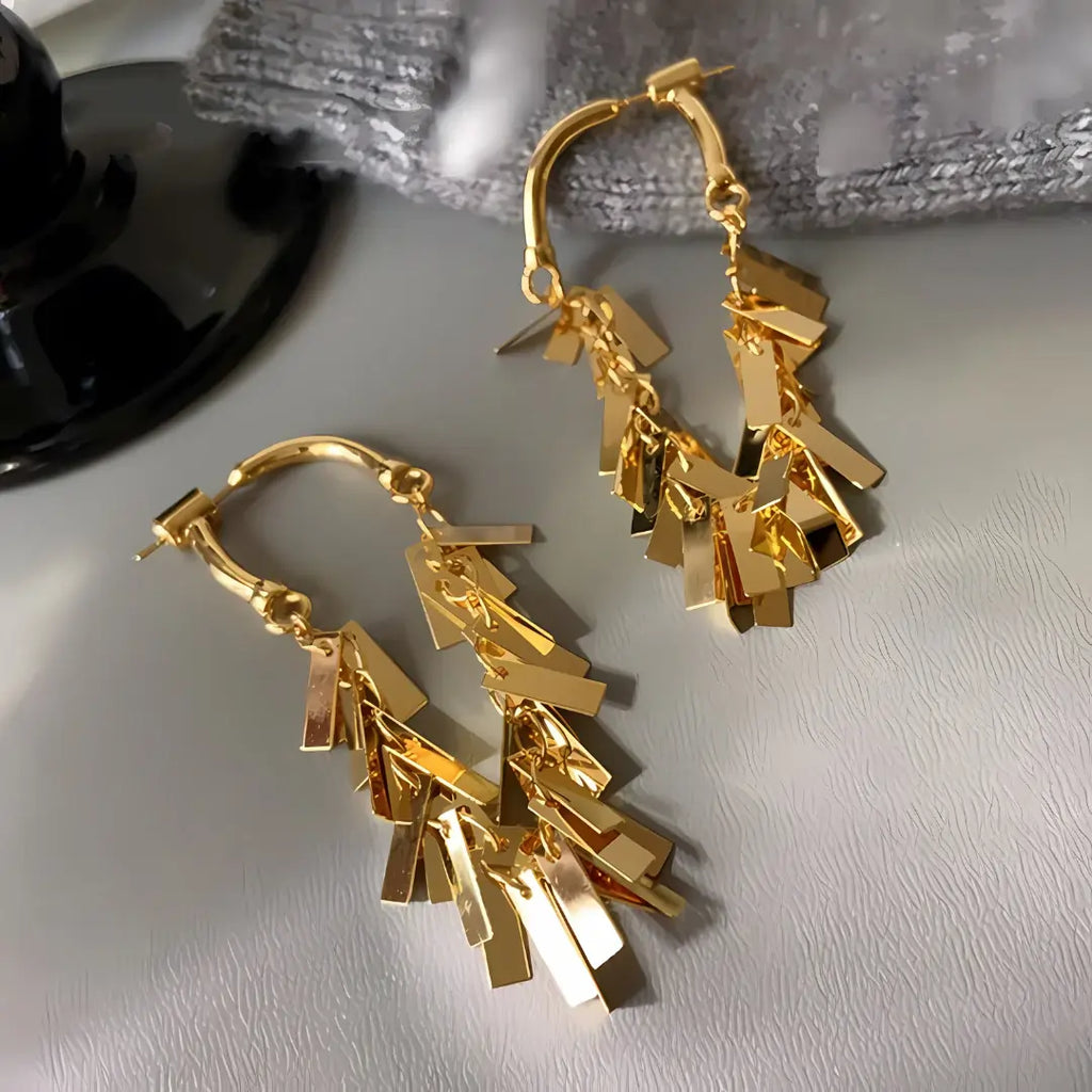 Gold earrings with sequin tassel dangling 