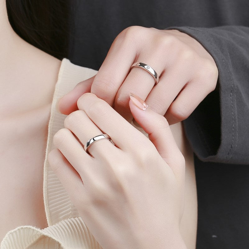 A couples wearing silver moon sun rings