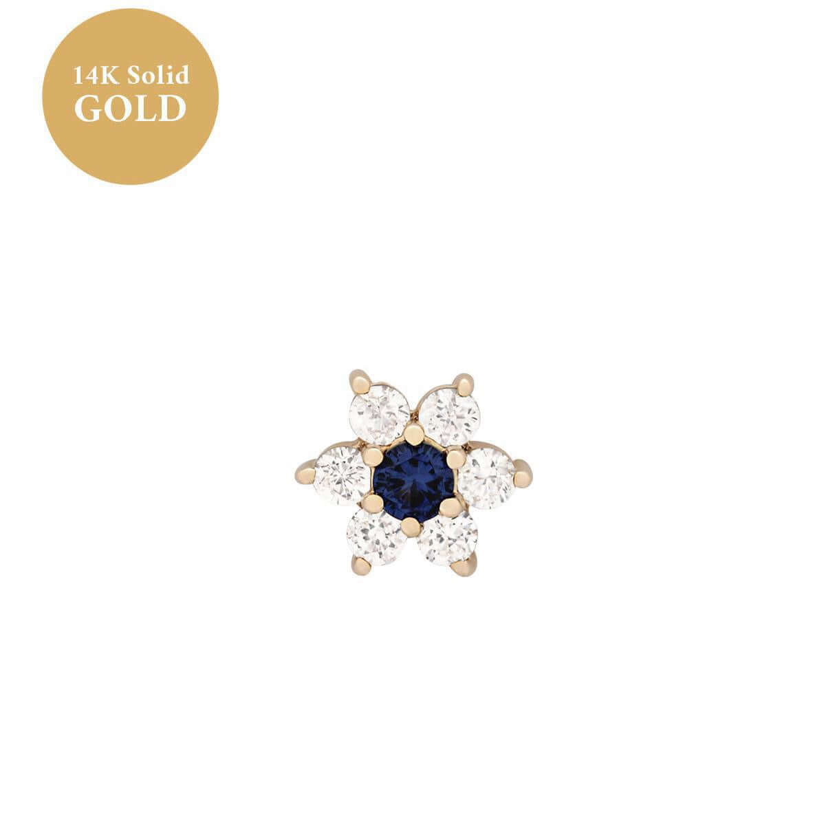 14K gold floral birthstone cartilage earrings featuring a blue center gemstone with surrounding clear stones, ideal for helix or daith piercings.