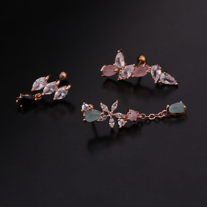 Trio of 20G cartilage dangle stud earrings in rose gold with CZ gemstones for tragus, helix, and daith piercings.