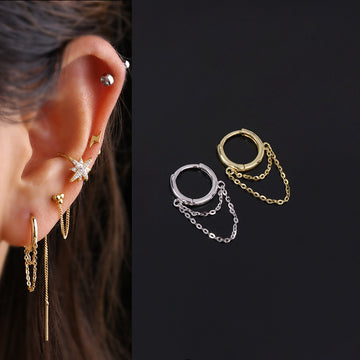 A pair of silver and gold cartilage tassel earrings with chain 