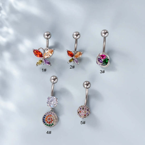 Surgical steel belly rings with gold plating and multicolored gemstones, displayed against a light background, labeled with sizes #1 to #5.