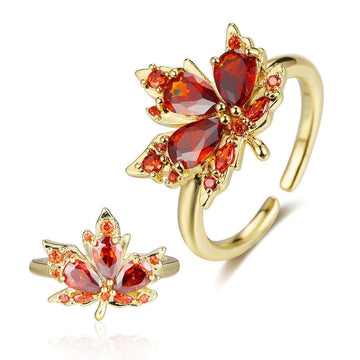 Gold and red gemstone leaf-shaped earrings on a white background