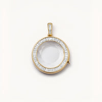 Gold pendant with a clear stone on a white background