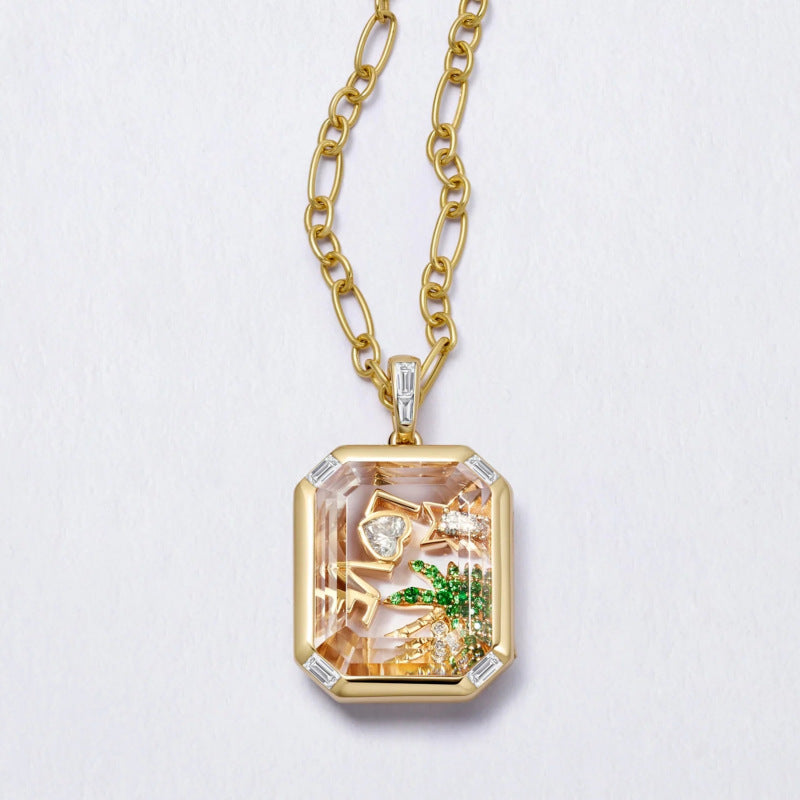Gold necklace with a pendant featuring a scenic design on a light gray background