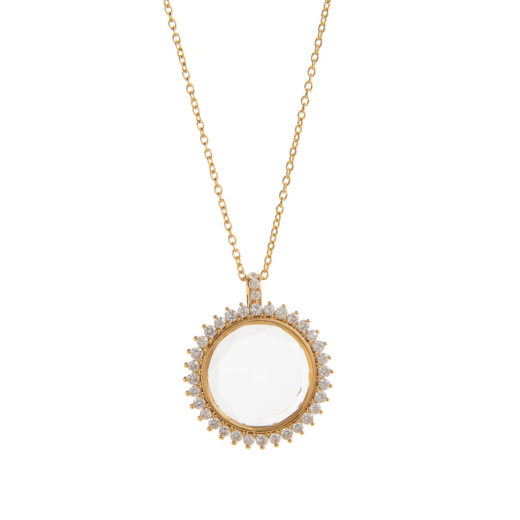Gold necklace with a round pendant on a white background