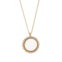 Gold necklace with a round pendant on a white background