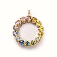 Gold pendant with heart-shaped multicolored gemstones on a white background