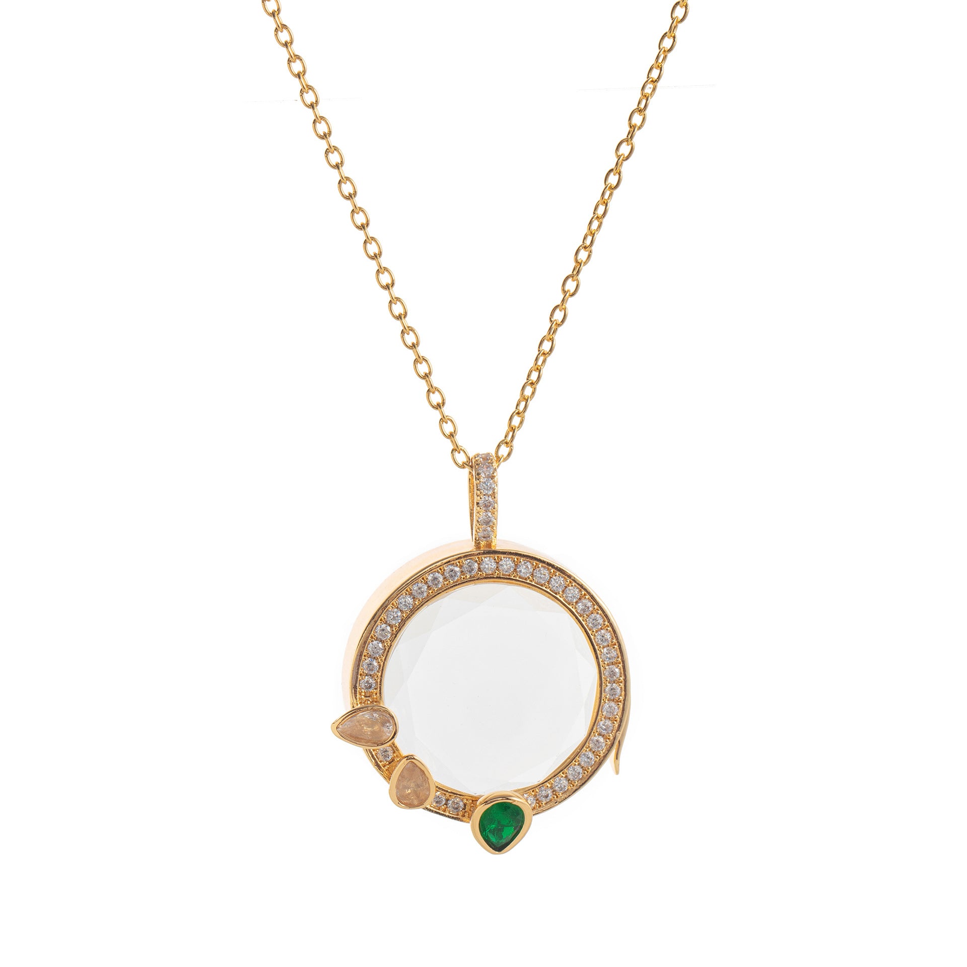 Gold necklace with a pendant featuring a white stone and green gem on a white background
