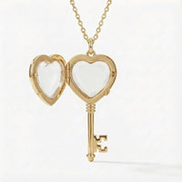 Gold heart-shaped key locket on a white background