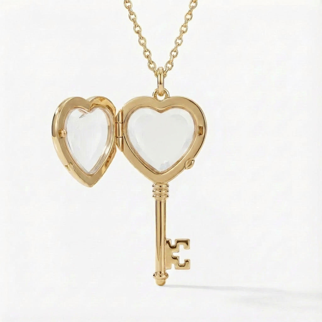 Gold heart-shaped key locket on a white background