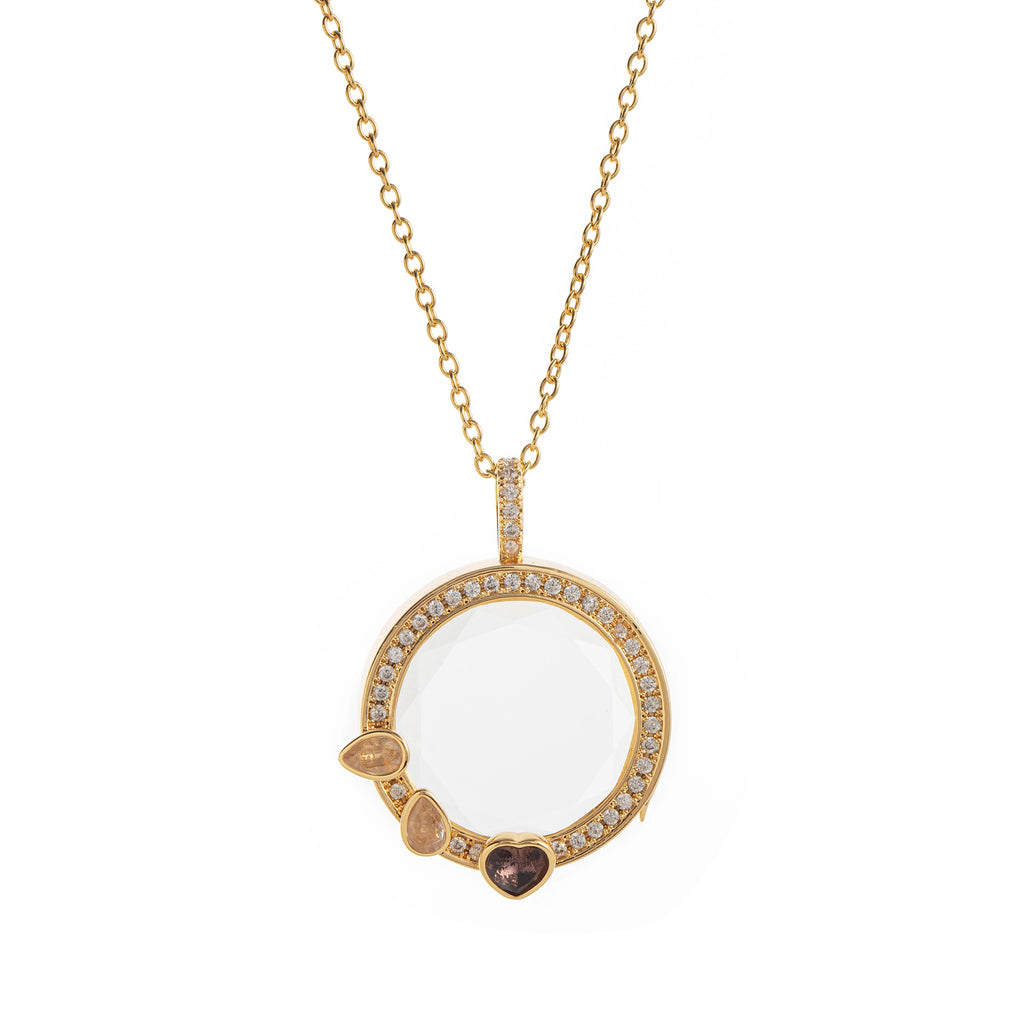 Gold necklace with a round pendant featuring gemstones on a white background