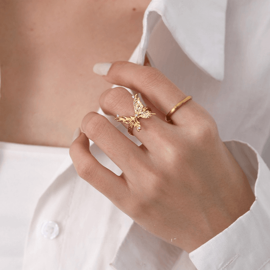 A women wear a bold gold large butterfly ring