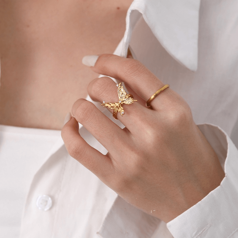 A women wear a bold gold large butterfly ring