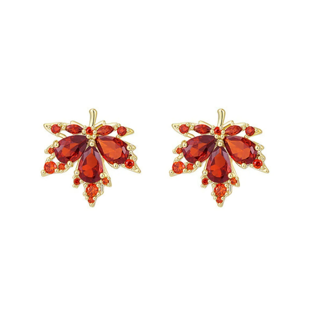Pair of orange gemstone earrings with gold accents on a white background