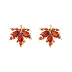 Pair of orange gemstone earrings with gold accents on a white background